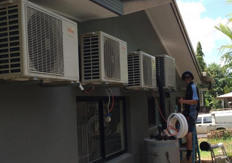 Tropicool technician repairing an air conditioner in Cairns